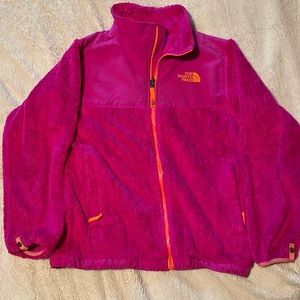 Pink fuzzy North Face jacket.